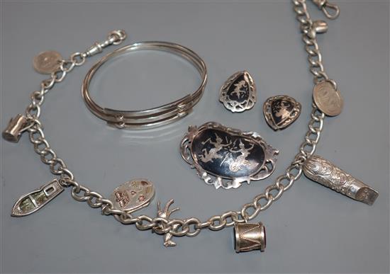 A silver charm bracelet, hung with nine charms including a Victorian locket, a 925 bangle and a Siamese sterling brooch & earclips.